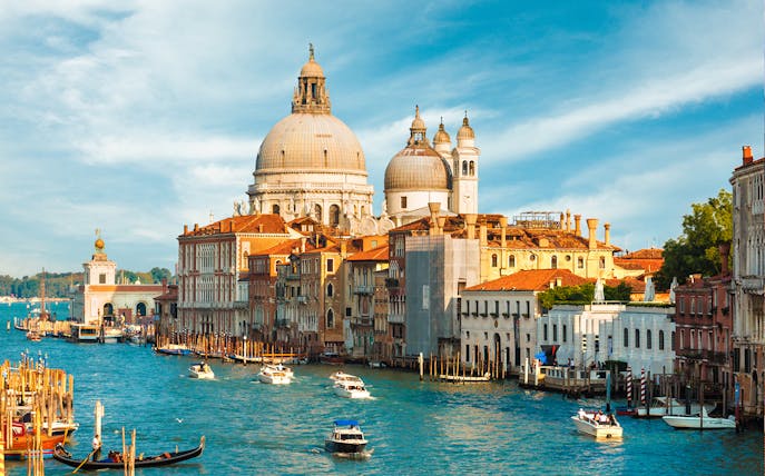 Grand Canal with Santa Maria della Salute in Venice, Italy, featuring gondolas and boats.