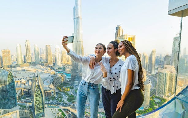 Group taking selfie with Burj Khalifa view from Sky View Dubai.