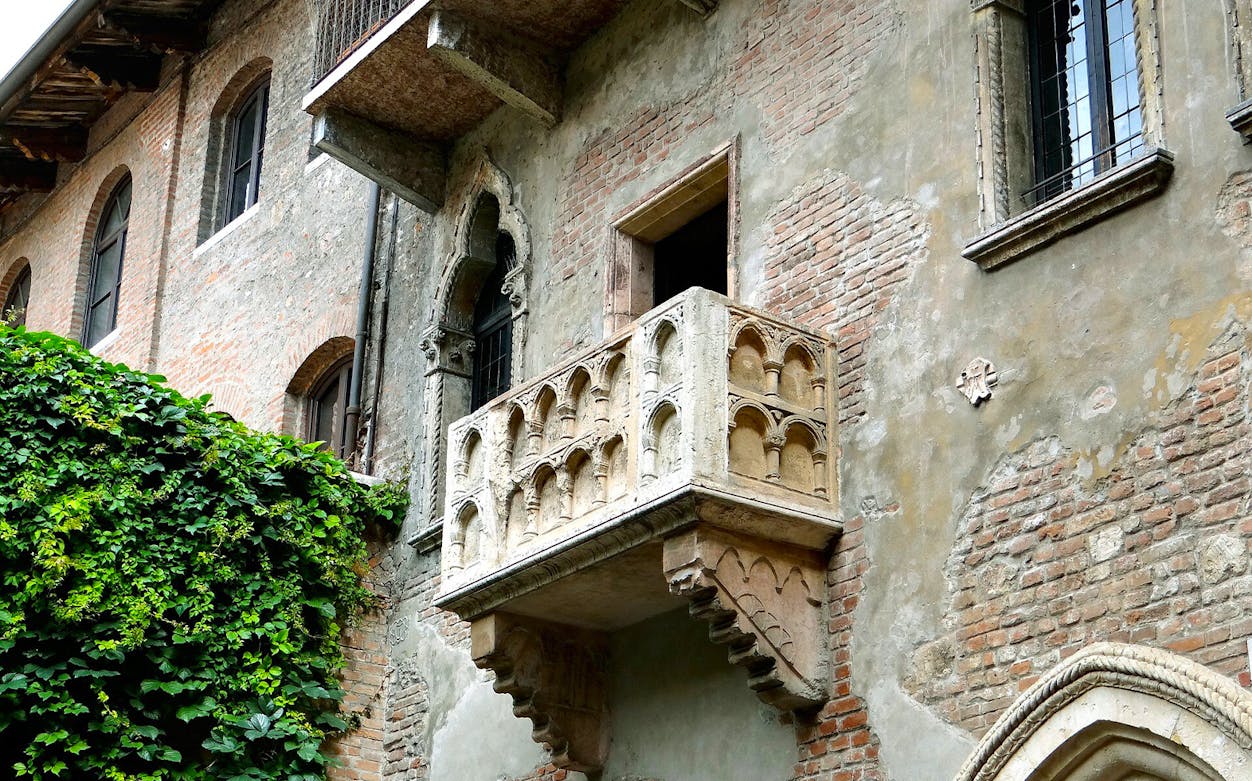 Juliet's balcony in Verona, Italy, covered in ivy, part of the self-guided audio tour.