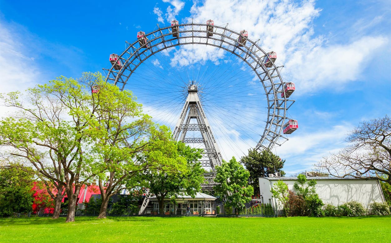 Vienna Ferris wheel in Prater Park on a sunny day, part of a self-guided audio tour.