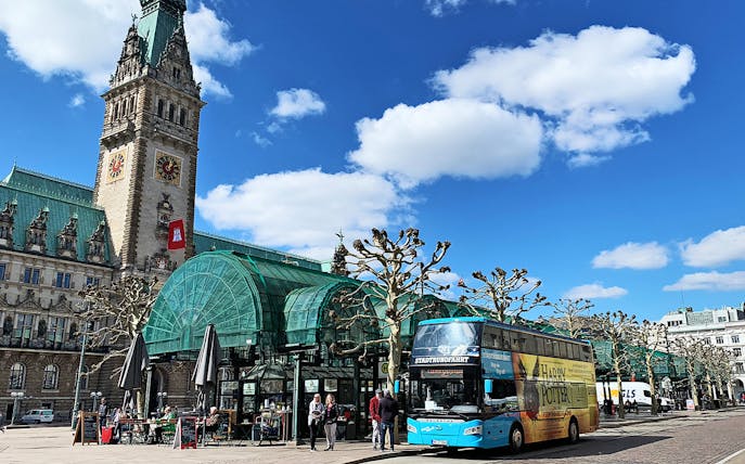 HopOn HopOff sightseeing bus in front of Hamburg City Hall, Germany.