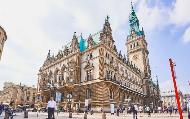 Hamburg City Hall with people walking in the foreground, part of the Historic Hamburg tour.