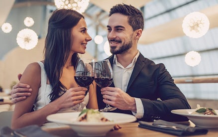 Couple enjoying a romantic Candle Flight Dinner with wine.