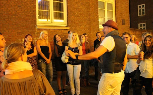 Tour guide engaging group on Reeperbahn, Hamburg's red light district.