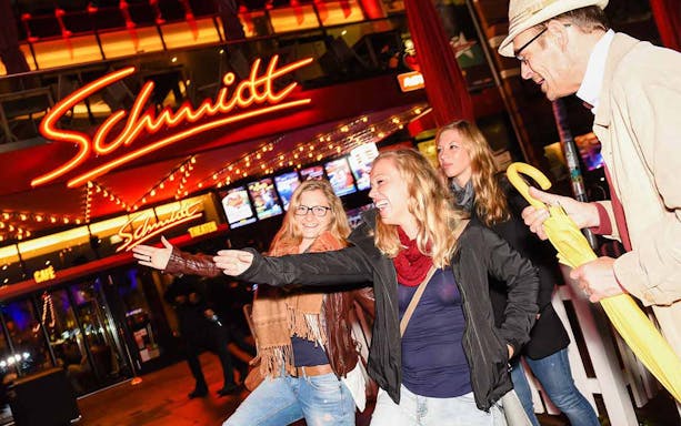 Group enjoying Reeperbahn nightlife during City Tour by Bus in Hamburg.
