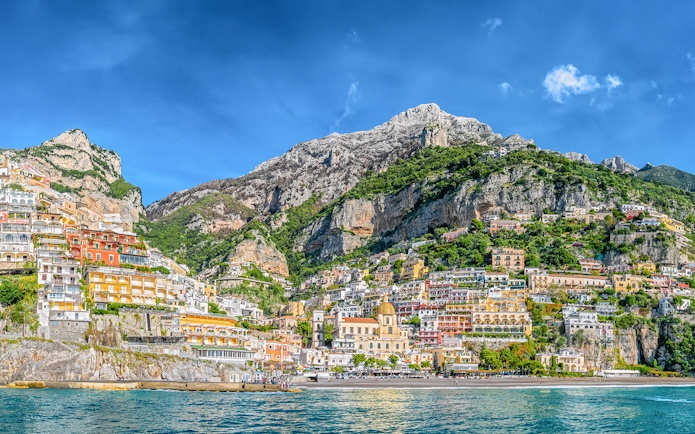 Positano cliffside view with colorful buildings and sea, part of Amalfi Coast tour from Naples.