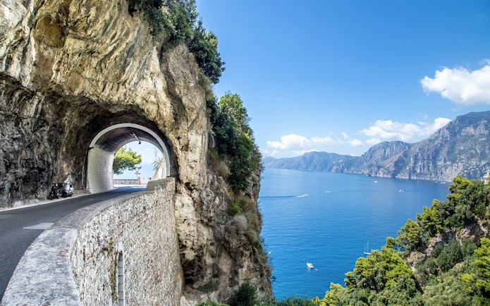 Tunnel road along the Amalfi Coast with sea view, part of the Positano, Amalfi & Ravello tour.
