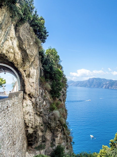 Tunnel road along the Amalfi Coast with sea view, part of the Positano, Amalfi & Ravello tour.