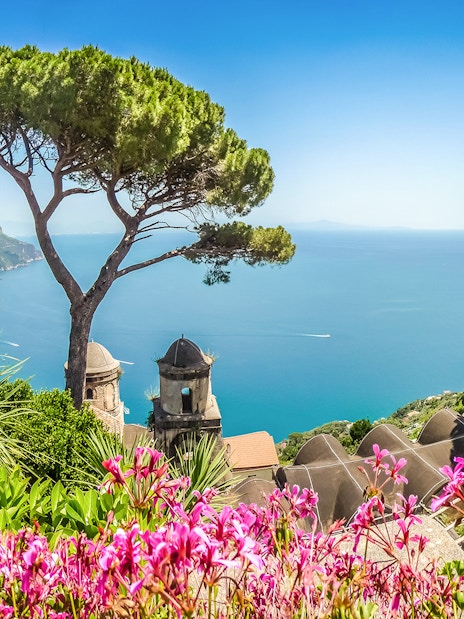 View of the Amalfi Coast from Ravello with vibrant flowers and Mediterranean Sea.