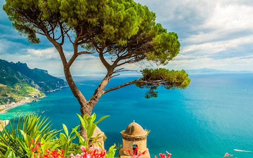 Coastal view of Amalfi with tree and sea, seen on a full-day tour from Naples.