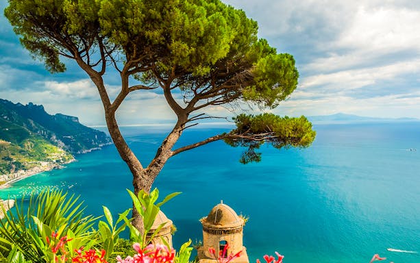 Coastal view of Amalfi with tree and sea, seen on a full-day tour from Naples.