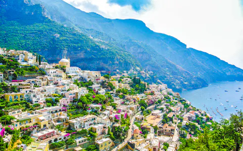 Sorrento coastline with colorful hillside buildings and view of the sea.
