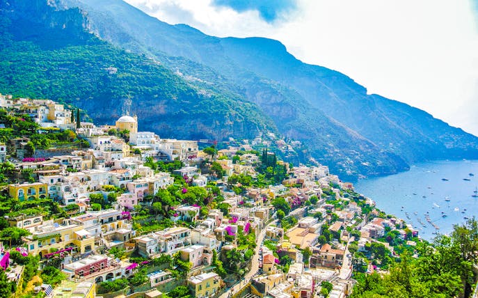 Sorrento coastline with colorful hillside buildings and view of the sea.