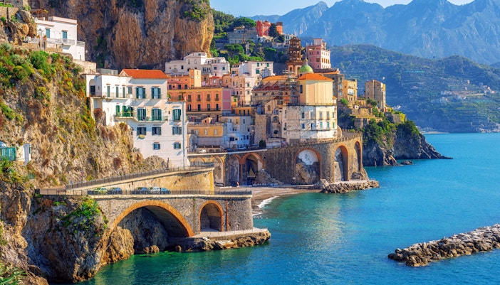 Sorrento coastline with colorful cliffside buildings and clear blue sea.