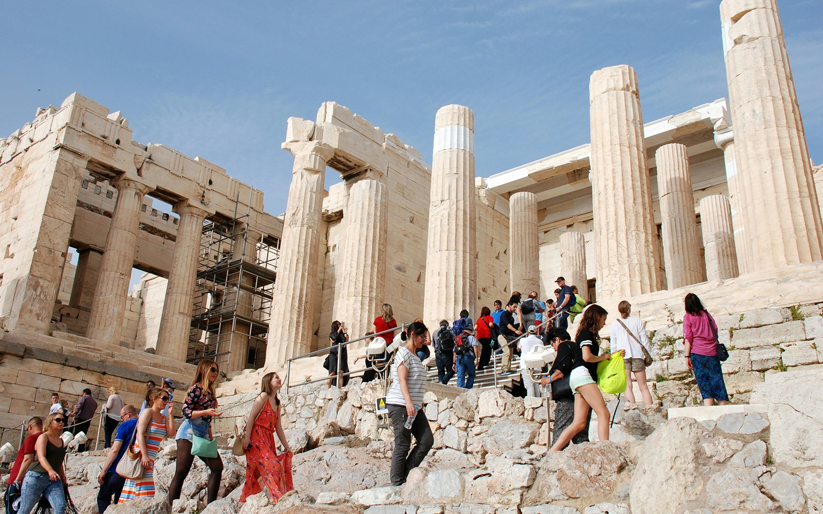 Visitors exploring the Propylaea entrance during the Acropolis of Athens afternoon walking tour.