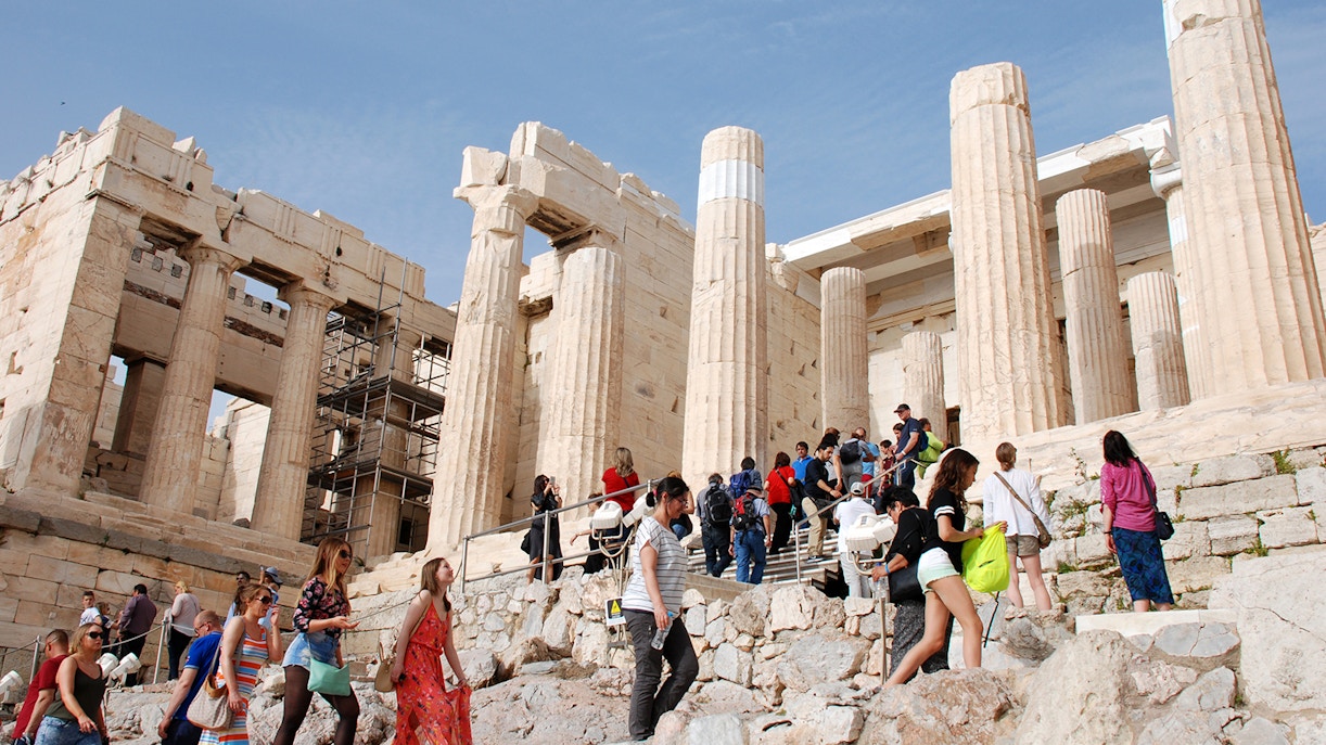 Visitors exploring the Propylaea entrance during the Acropolis of Athens afternoon walking tour.