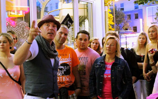 Tour guide leading a group through St. Pauli district in Hamburg.