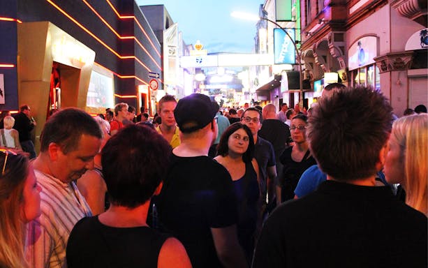 Crowd exploring vibrant nightlife on St. Pauli guided tour in Hamburg.