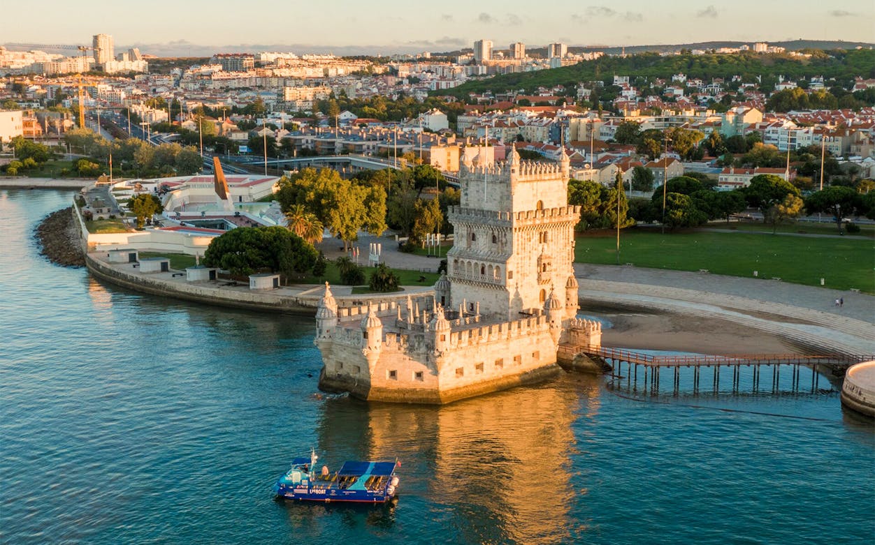 Belem Tower and cruise boat on the Tagus River, Lisbon.