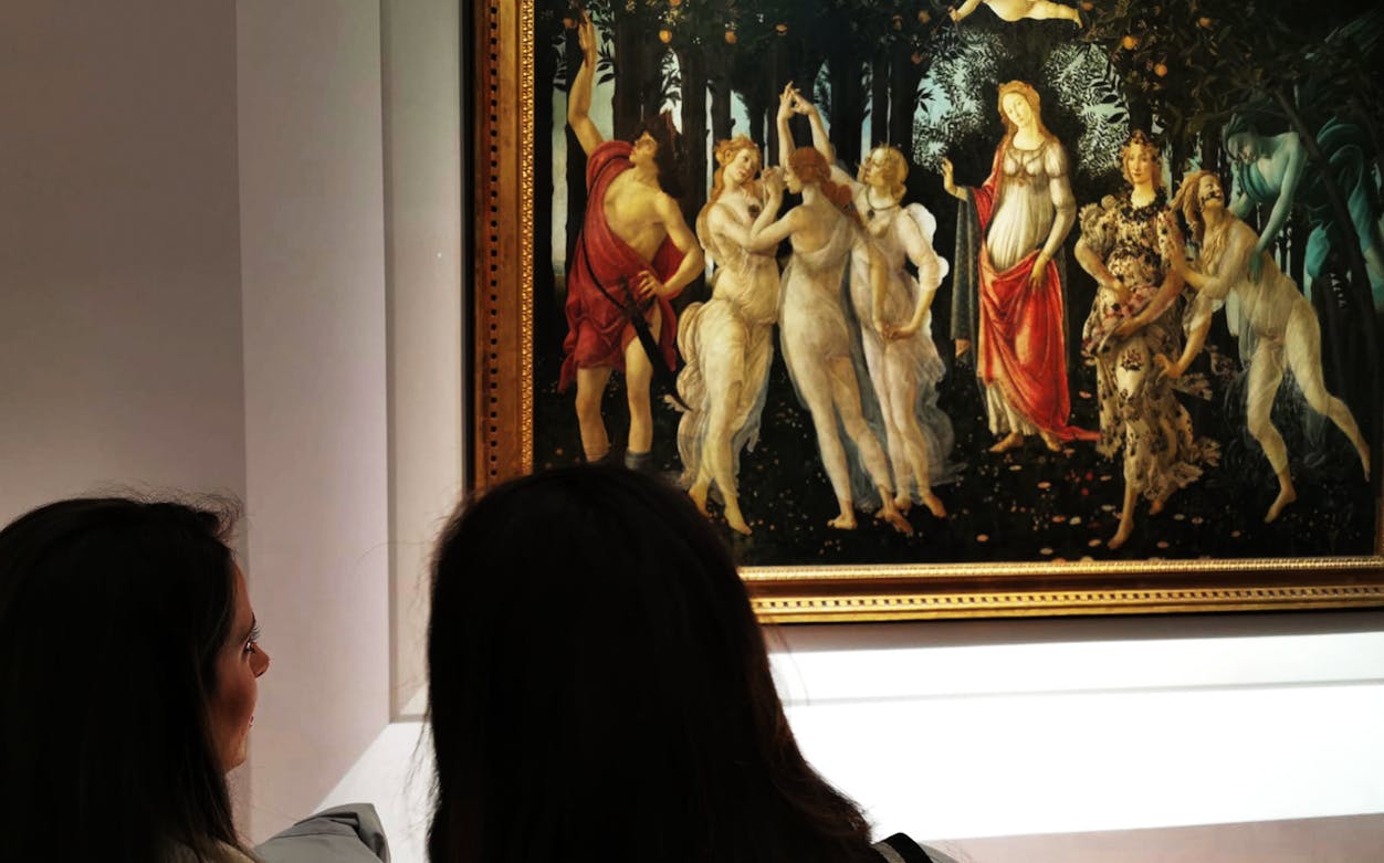 Visitors viewing Botticelli's "Primavera" at Uffizi Gallery, Florence.