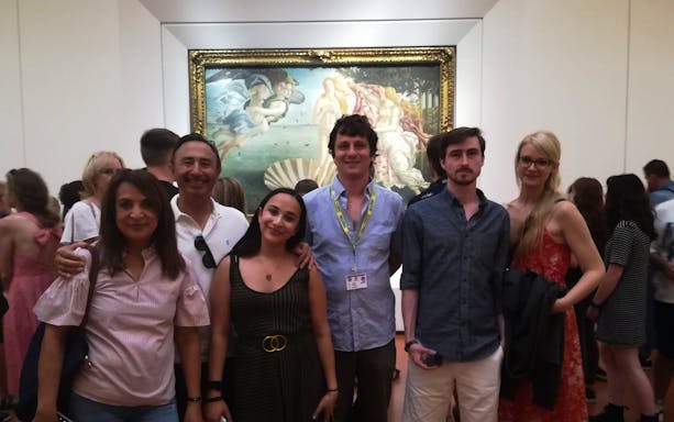 Visitors at Uffizi Gallery with Botticelli's "The Birth of Venus" in the background.