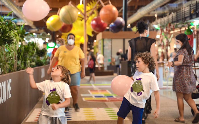 Children playing with balloons at FICO Eataly World, Bologna.