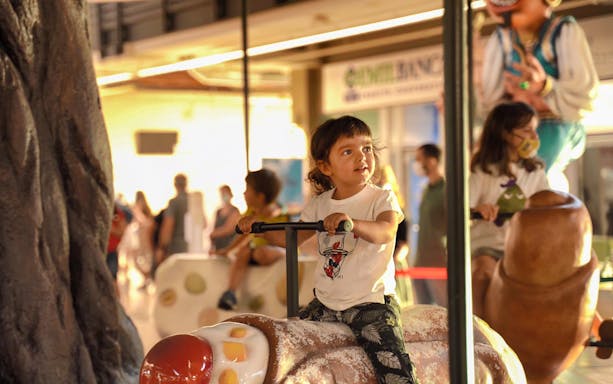 Child enjoying a ride at FICO Eataly World, Bologna.