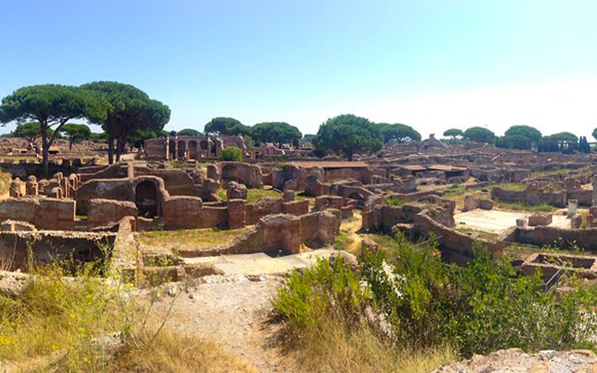 Ancient ruins and trees at Ostia Archaeological Park, Italy.