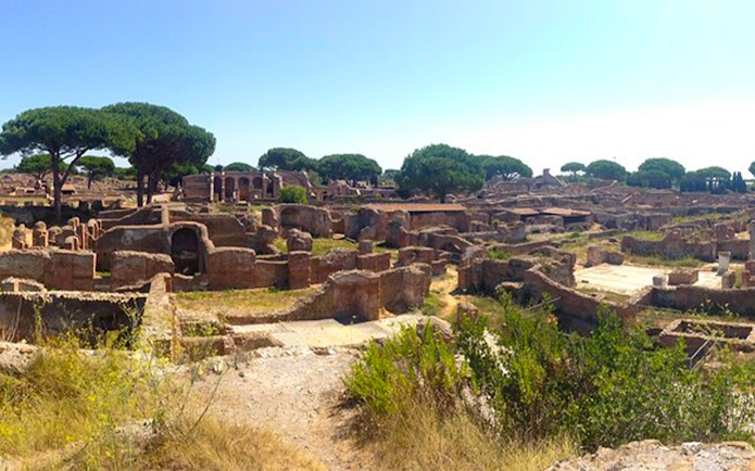 Ancient ruins and trees at Ostia Archaeological Park, Italy.