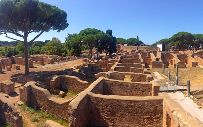 Ancient ruins and trees at Ostia Archaeological Park, Italy.