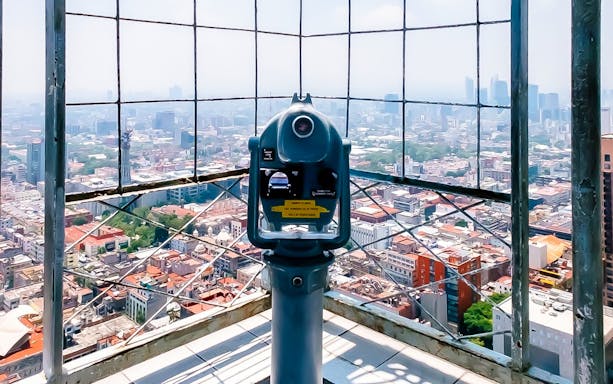Viewing platform telescope overlooking Mexico City skyline from Torre Latino.