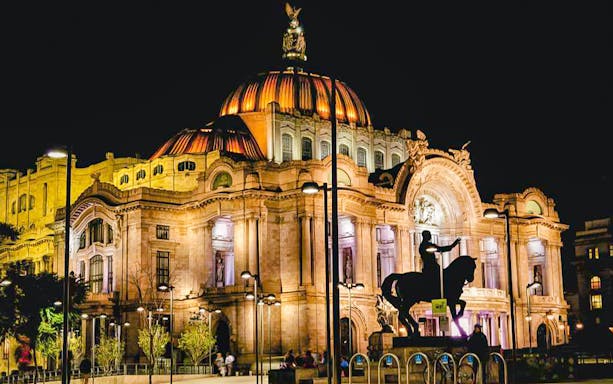 Palacio de Bellas Artes illuminated at night, Mexico City tour.