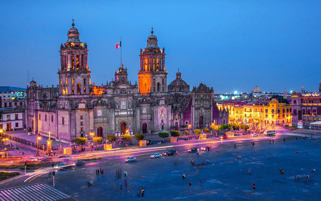 Mexico City Metropolitan Cathedral illuminated at night, view from Zócalo.
