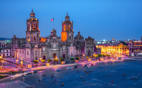 Mexico City Metropolitan Cathedral illuminated at night, view from Zócalo.