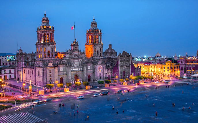 Mexico City Metropolitan Cathedral illuminated at night, view from Zócalo.