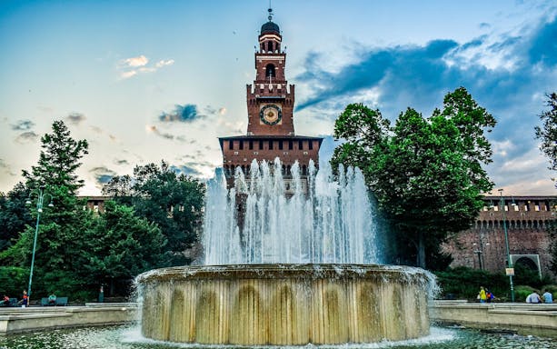 Sforza Castle tower and fountain in Milan during a self-guided tour.