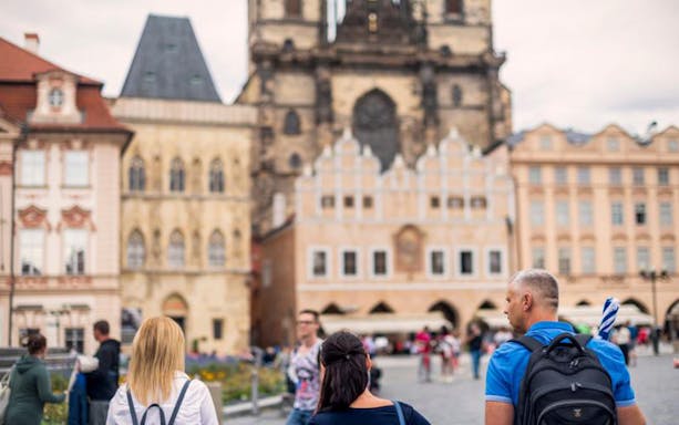 Tourists exploring Old Town Square in Prague during the Franz Kafka tour.