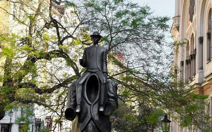 Franz Kafka statue in Prague, featuring a headless figure carrying Kafka, part of the 2.5-hour tour.