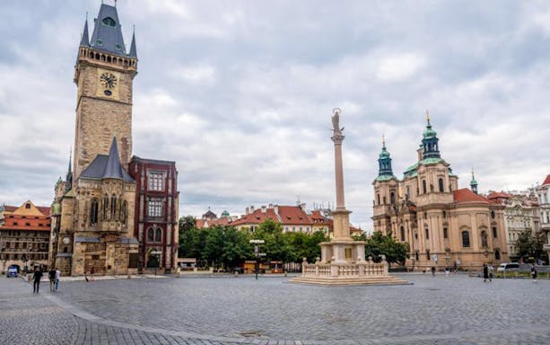 Old Town Square with Prague's Astronomical Clock Tower and St. Nicholas Church, Franz Kafka Prague Tour.