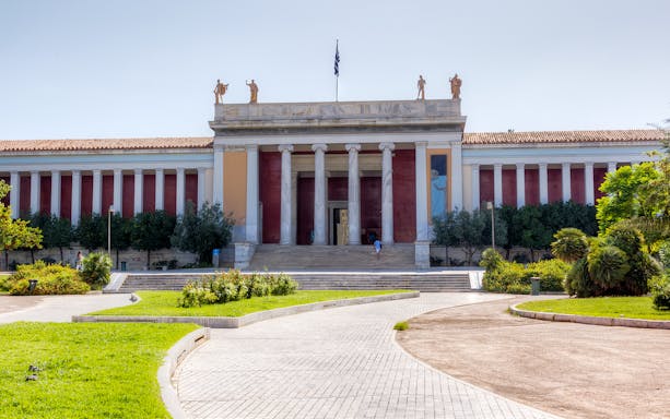 National Archaeological Museum entrance with columns and statues in Athens.
