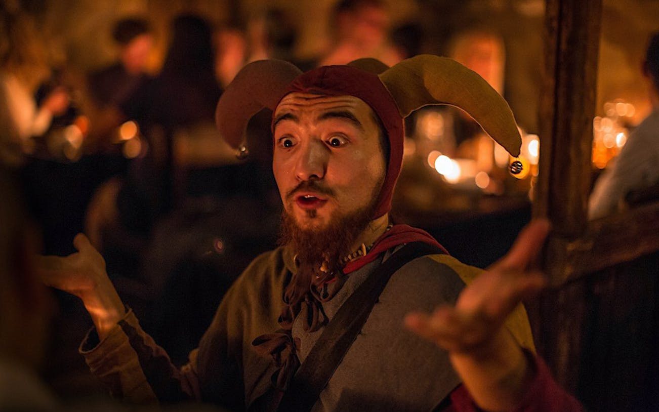 Jester performing at a medieval dinner on New Year's Eve.