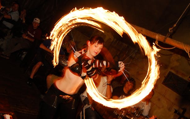 Fire performer at a medieval dinner event on New Year's Eve.