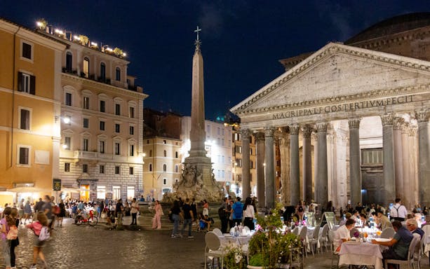 Pantheon at night with people dining and exploring during Rome's Ghosts and Mysteries tour.