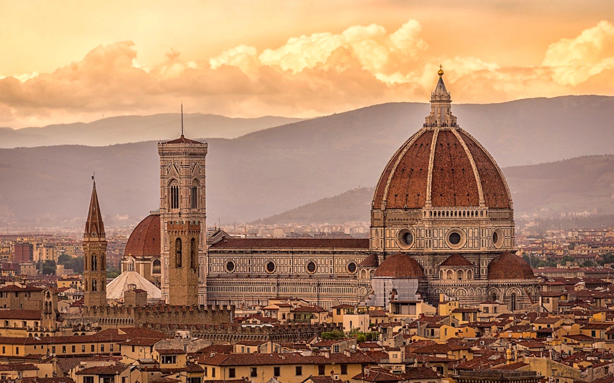 Florence skyline featuring Brunelleschi's Dome and Giotto's Campanile at sunset.