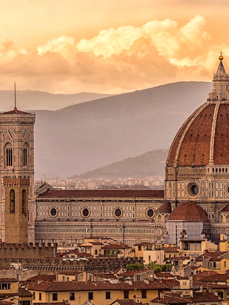Florence skyline featuring Brunelleschi's Dome and Giotto's Campanile at sunset.