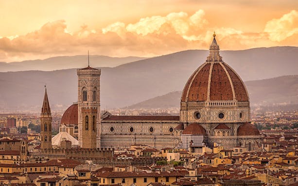 Florence skyline featuring Brunelleschi's Dome and Giotto's Campanile at sunset.