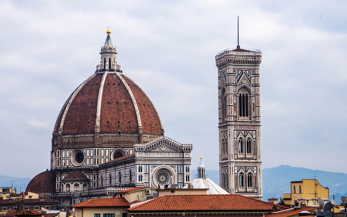 Florence Duomo and Giotto's Campanile under cloudy sky.