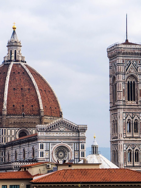 Florence Duomo and Giotto's Campanile under cloudy sky.