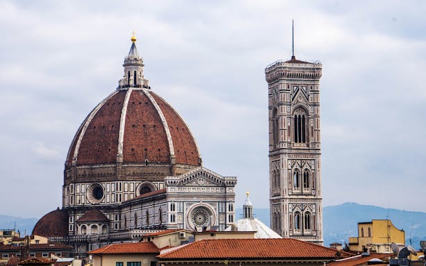 Florence Duomo and Giotto's Campanile under cloudy sky.