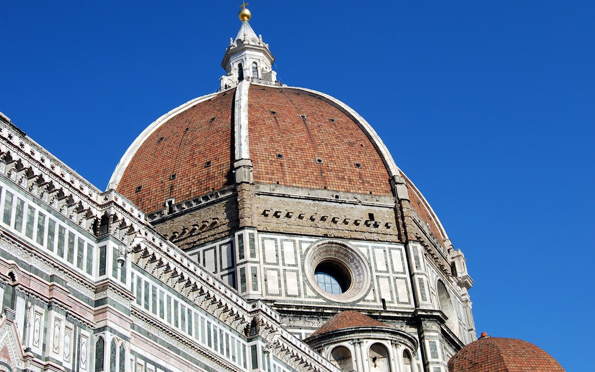 Brunelleschi's Dome on Florence Cathedral under clear blue sky.